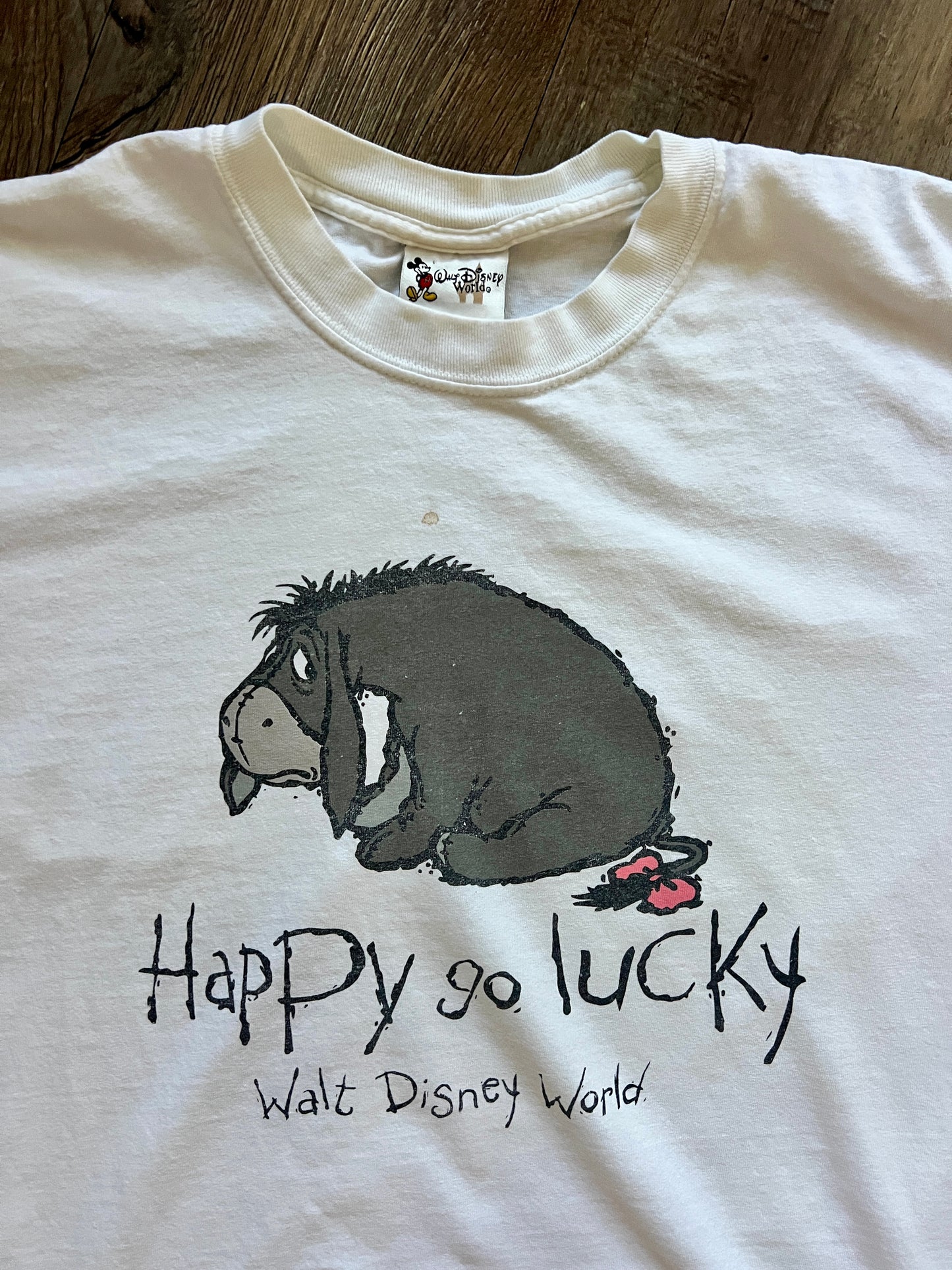 599 -White Eeyore Happy Go Lucky WDW Logo Tee - M